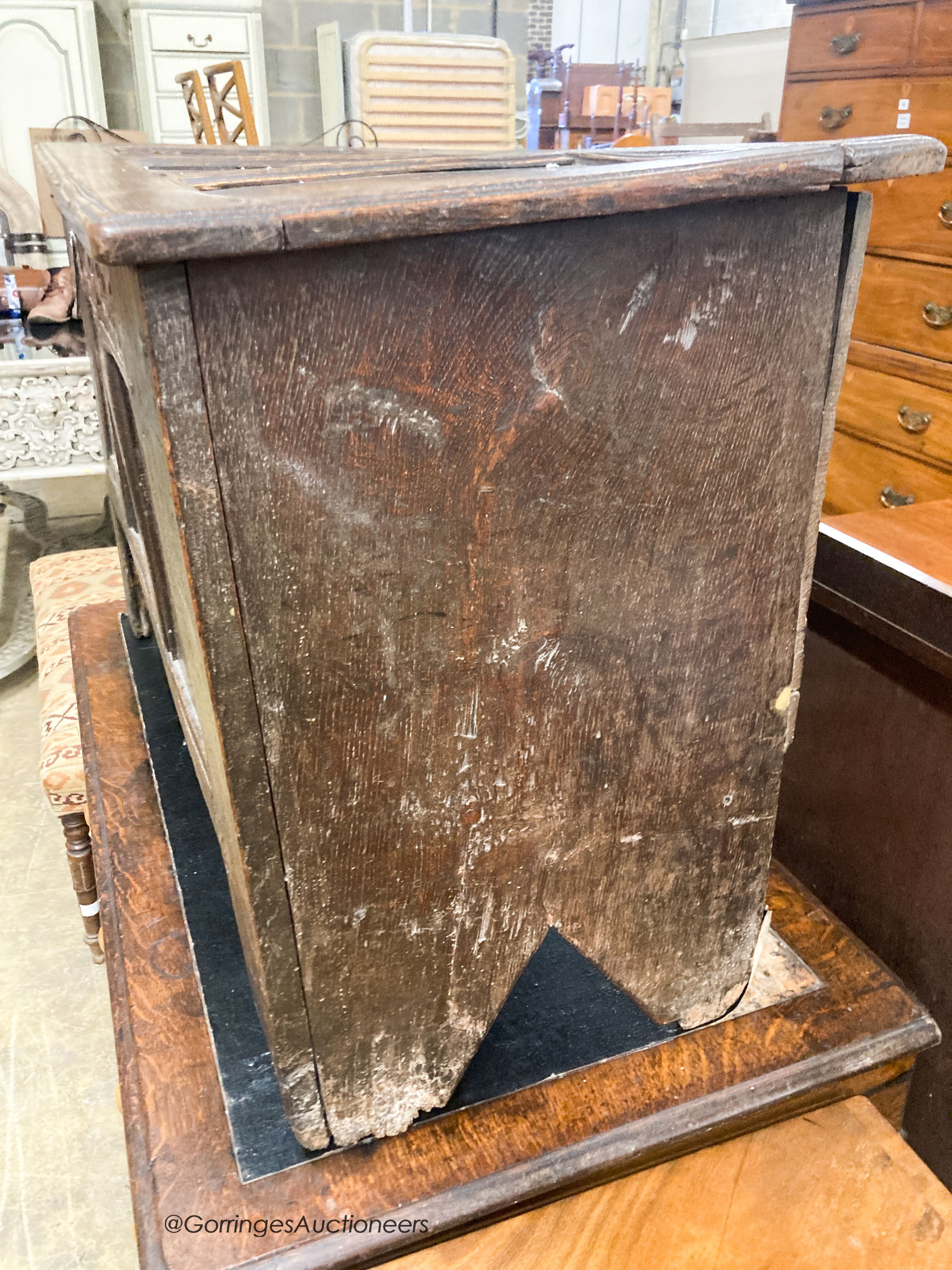 A 17th century caved panelled oak coffer, W.110cm D.48cm H.67cm